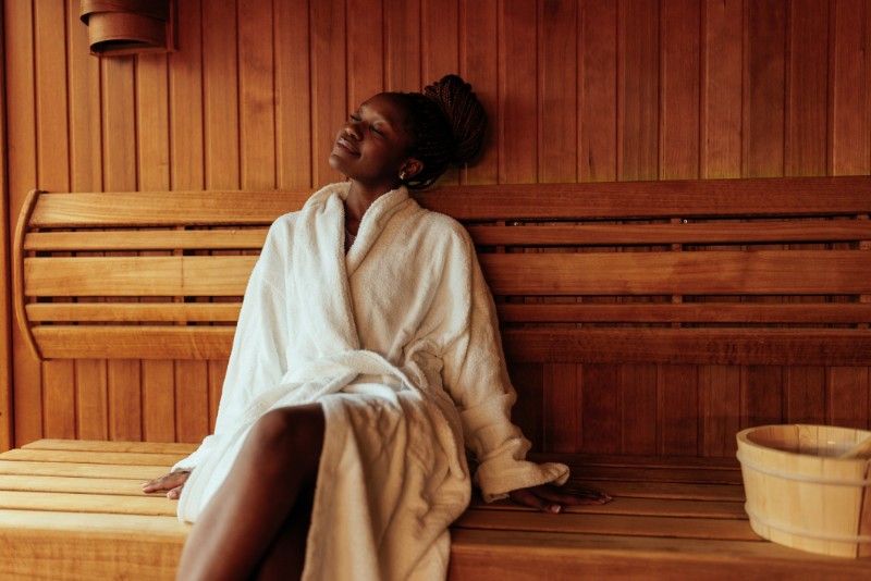 Young black woman enjoying in sauna